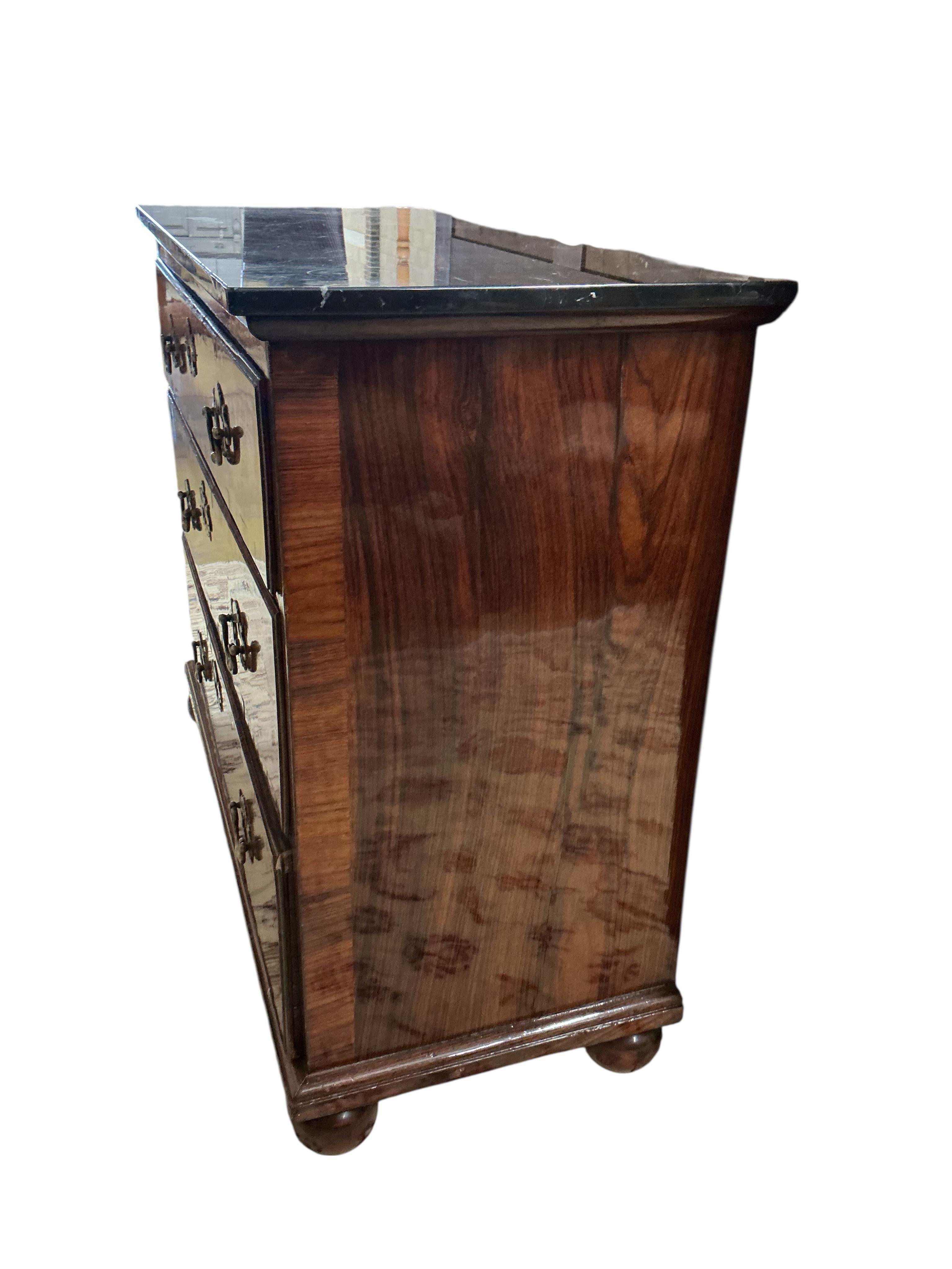 An 18th century and later rosewood veneered chest with associated reconstituted black marble top, width 106cm, depth 46cm, height 88cm
